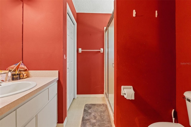 full bathroom featuring tile patterned flooring, toilet, vanity, baseboards, and a shower stall