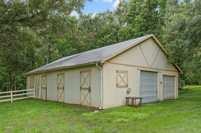 view of outbuilding featuring fence and an outdoor structure