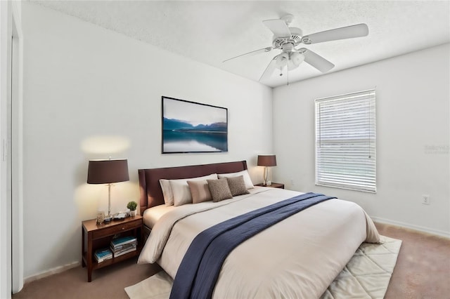 bedroom with a ceiling fan, carpet, and baseboards