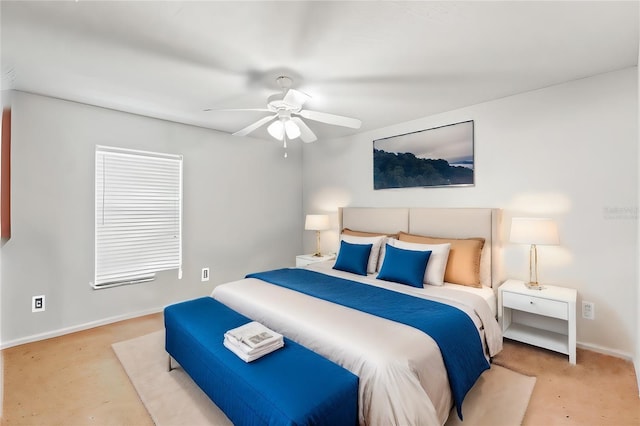 bedroom with ceiling fan and baseboards