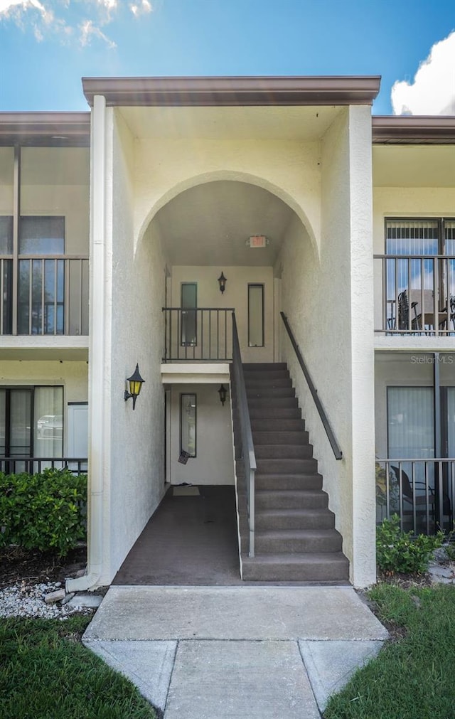 view of exterior entry with a balcony