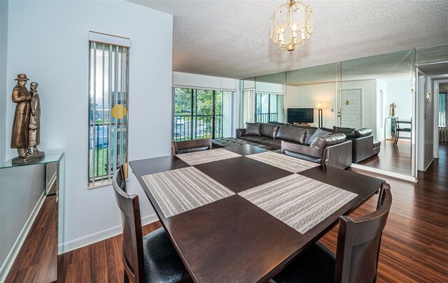 dining area featuring an inviting chandelier, dark hardwood / wood-style flooring, and a textured ceiling