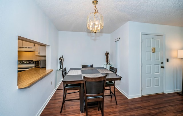 dining room featuring dark hardwood / wood-style floors, a textured ceiling, and an inviting chandelier