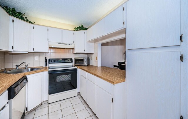 kitchen with white appliances, white cabinets, sink, backsplash, and light tile patterned flooring