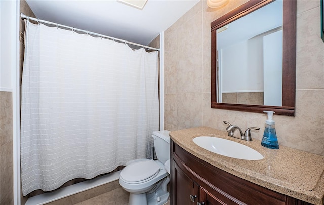 bathroom featuring tile patterned floors, tile walls, vanity, and toilet