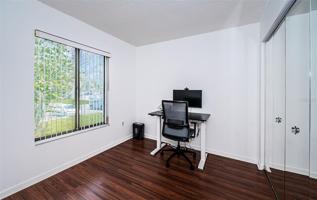 home office featuring hardwood / wood-style flooring, a textured ceiling, and plenty of natural light