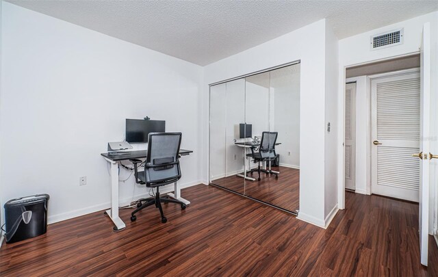 office with dark hardwood / wood-style floors and a textured ceiling