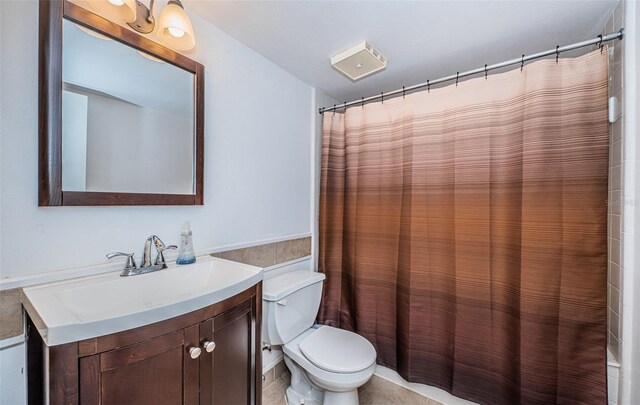 bathroom featuring tile patterned floors, vanity, and toilet