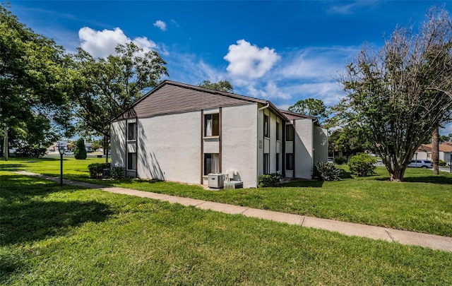 view of side of home featuring a yard