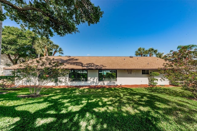 ranch-style house featuring a front lawn