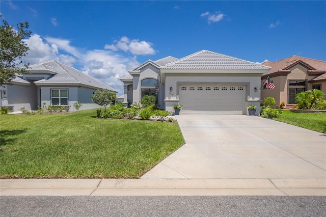 view of front of house featuring a front yard, a tile roof, an attached garage, and stucco siding