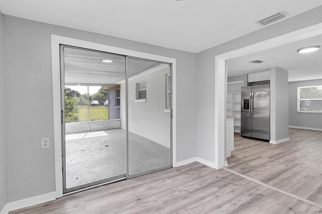 doorway to outside featuring light wood-type flooring