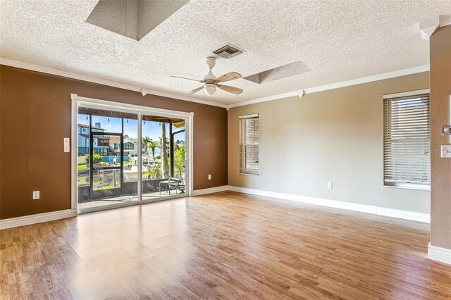 6316 Spoonbill Dr, New Port Richey, FL 34652 - unfurnished room with light wood-type flooring, visible vents, a skylight, a ceiling fan, and crown molding