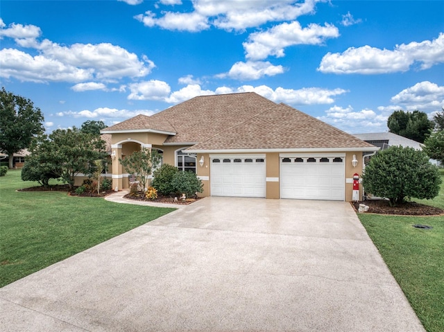 view of front of house with a garage and a front yard