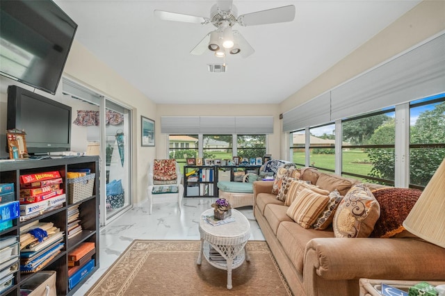 sunroom featuring ceiling fan