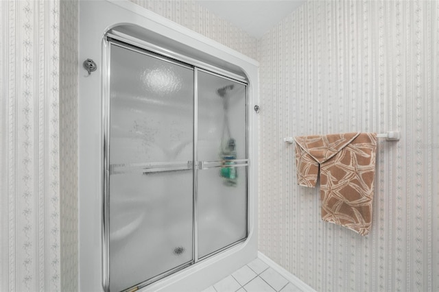 bathroom featuring tile patterned flooring and an enclosed shower