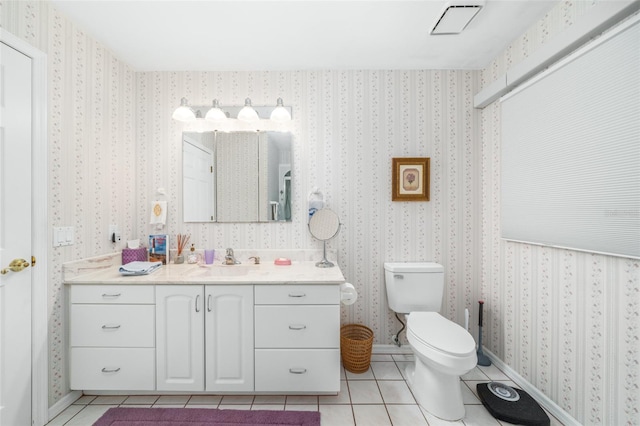 bathroom featuring toilet, vanity, and tile patterned floors