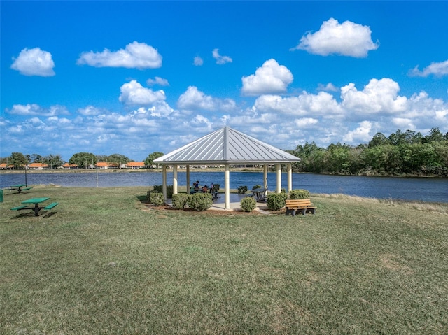 dock area with a water view, a yard, and a gazebo