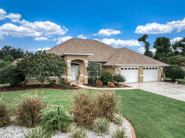 view of front of property with a garage and a front yard