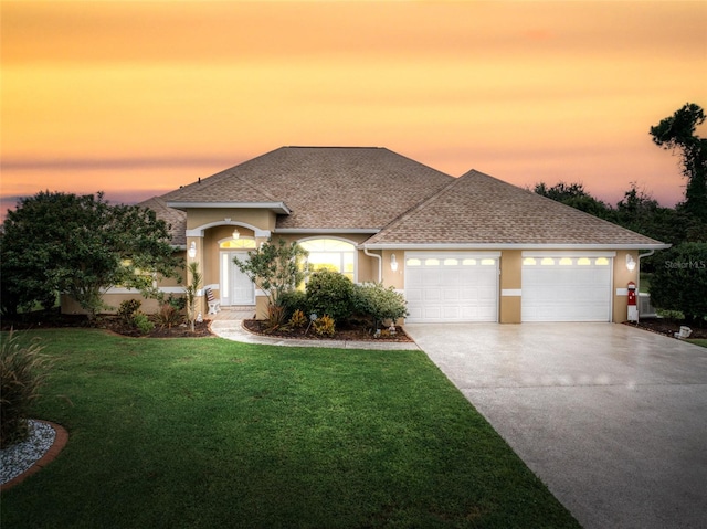 view of front facade with a lawn and a garage