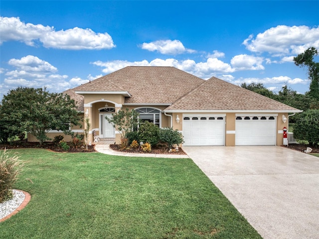 view of front of home with a garage and a front lawn