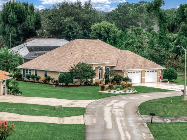 view of front facade with a front lawn and a garage