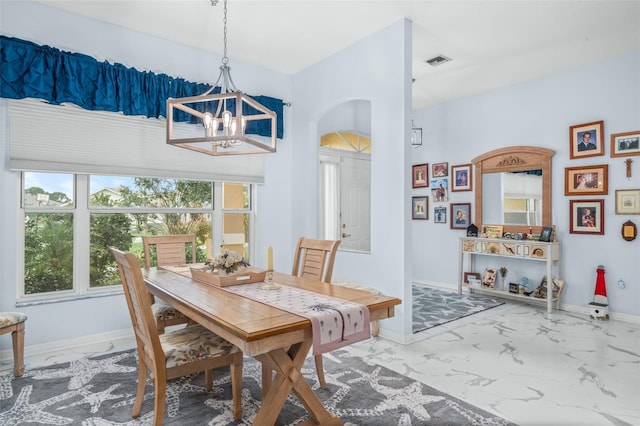 dining area featuring a notable chandelier