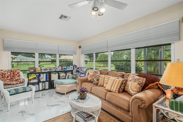 sunroom featuring ceiling fan and a healthy amount of sunlight