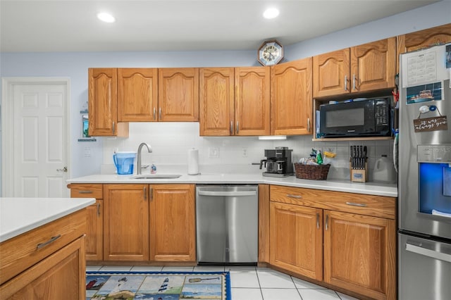 kitchen featuring tasteful backsplash, appliances with stainless steel finishes, sink, and light tile patterned floors