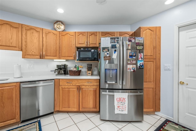 kitchen with decorative backsplash, light tile patterned flooring, and stainless steel appliances