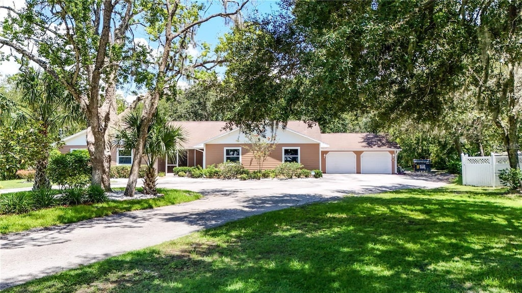 single story home featuring a front yard and a garage