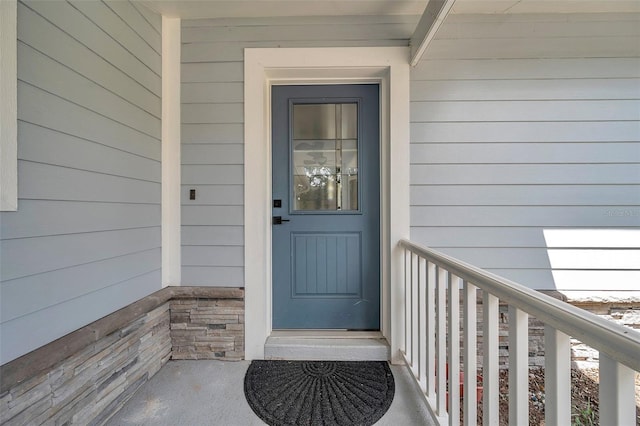 doorway to property featuring stone siding