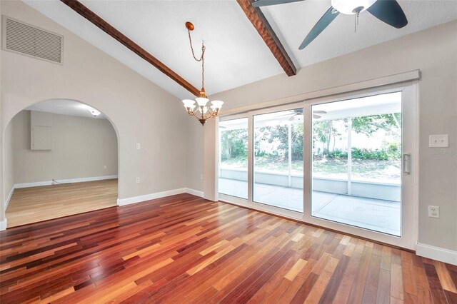 empty room with hardwood / wood-style floors, ceiling fan with notable chandelier, and vaulted ceiling with beams