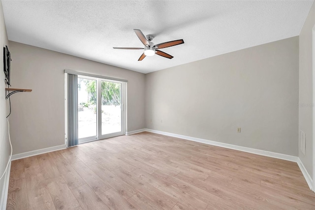 spare room featuring light wood-style floors, ceiling fan, and baseboards