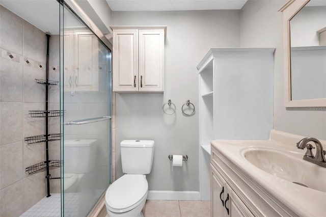 bathroom featuring toilet, tile patterned floors, vanity, and an enclosed shower