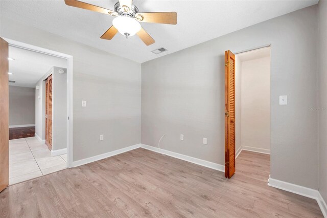 spare room featuring ceiling fan and light wood-type flooring