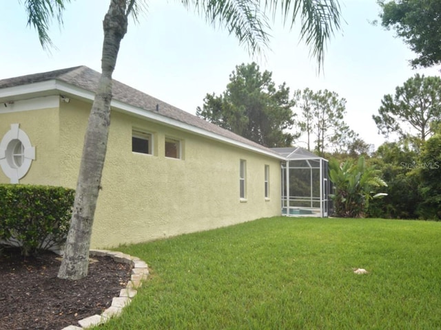 view of yard featuring glass enclosure