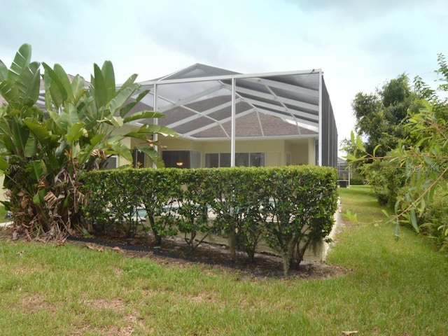 view of yard with glass enclosure