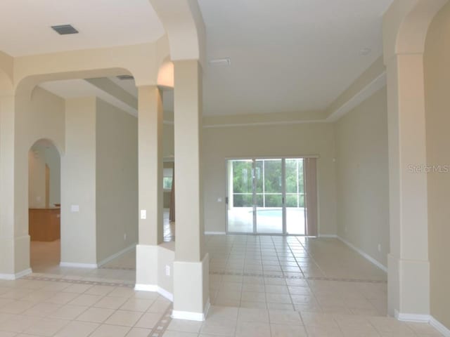 tiled spare room with a towering ceiling