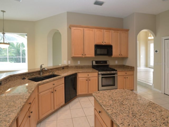 kitchen with pendant lighting, light brown cabinetry, sink, and black appliances