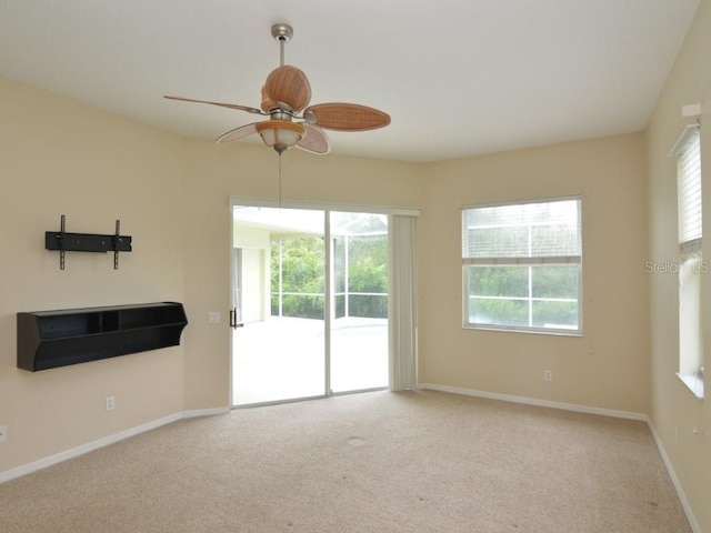 carpeted empty room with ceiling fan