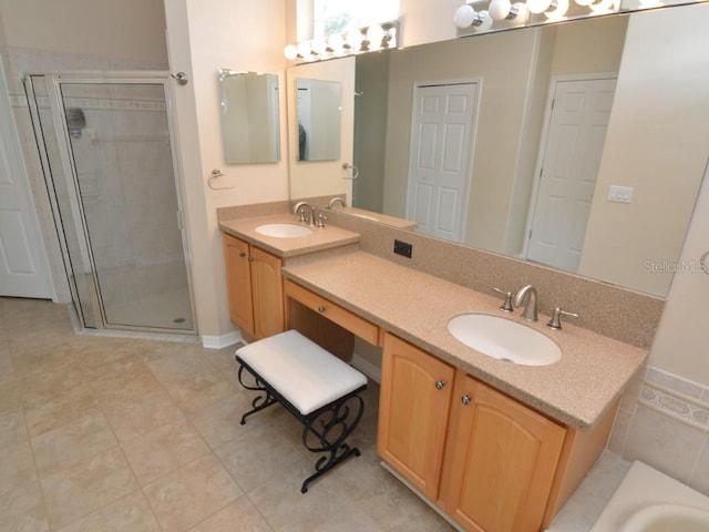 bathroom featuring tile patterned floors, vanity, and an enclosed shower