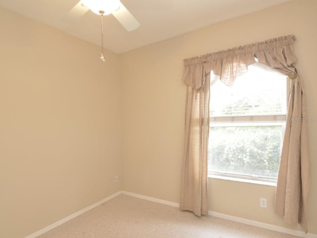 carpeted empty room featuring ceiling fan