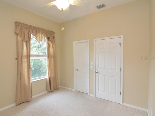 unfurnished bedroom featuring light carpet and ceiling fan