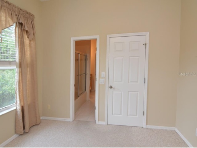 carpeted spare room featuring a wealth of natural light