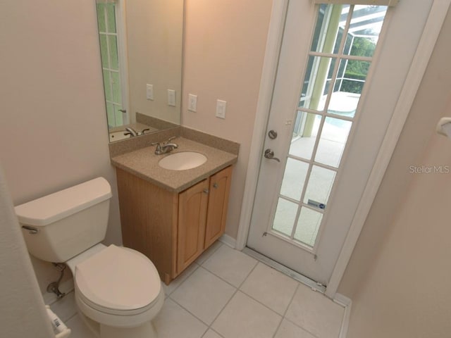 bathroom with vanity, tile patterned floors, and toilet