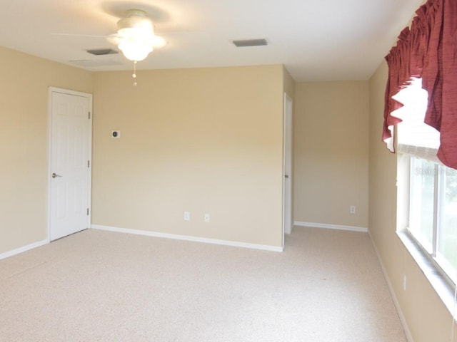 carpeted empty room featuring ceiling fan