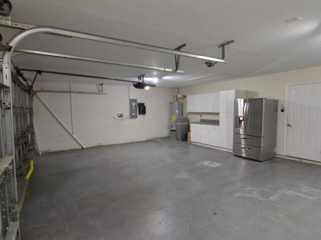 garage featuring stainless steel fridge with ice dispenser, electric panel, and water heater