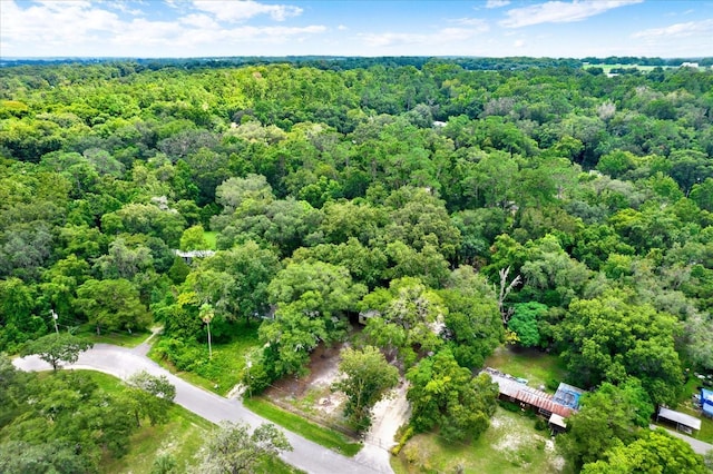 birds eye view of property with a wooded view