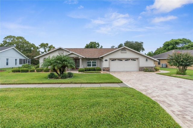 single story home featuring a garage and a front yard